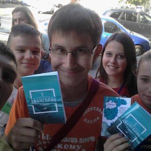 Youth handing out Gospels of John